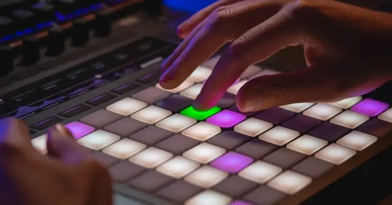 Person typing on keyboard in dark room with neon lighting