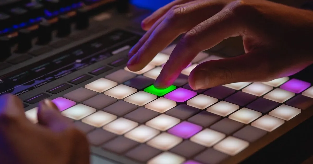 Person typing on keyboard in dark room with neon lighting